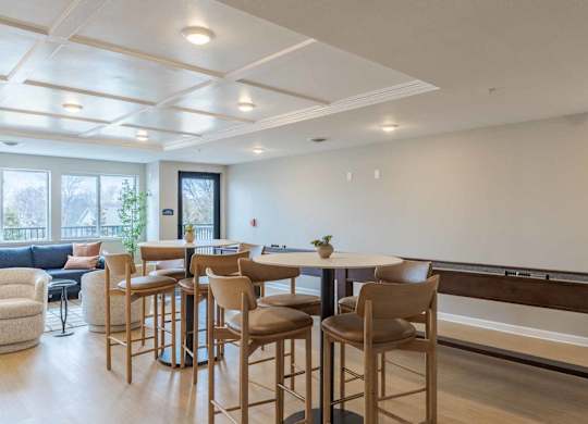 A modern kitchen with a dining table and chairs.