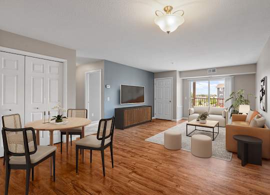 a living room and dining room with a couch and a tv