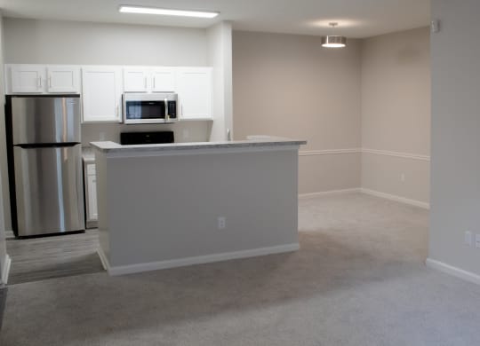 Enclave at Wolfchase Apartments in Cordova Tennessee photo of an open living room with a kitchen in the background