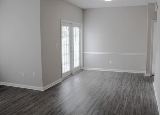 Enclave at Wolfchase Apartments in Cordova Tennessee photo of an empty living room with a door and a window