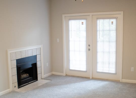 Enclave at Wolfchase Apartments in Cordova Tennessee photo of a living room with a fireplace and a ceiling fan