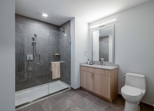 a bathroom with a toilet sink and shower