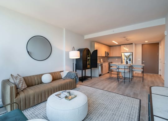 a living room with a couch and a table and a kitchen