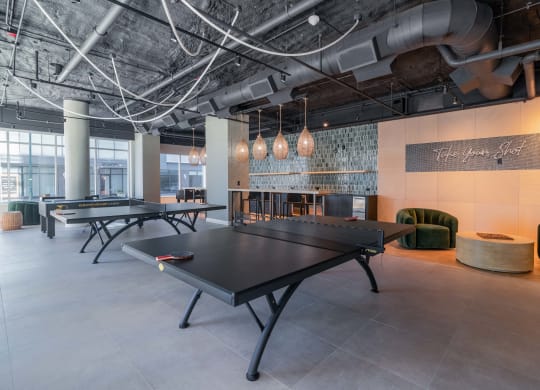 a games room with ping pong tables and other gaming equipment