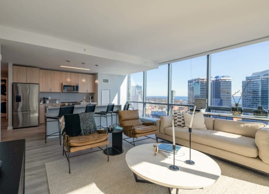 a living room with a view of the city and a couch and a table