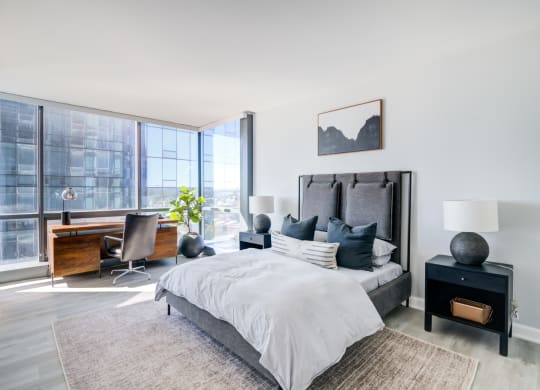 a bedroom with a bed and a large window