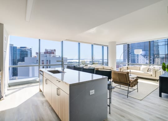 a kitchen and living room with a view of the city
