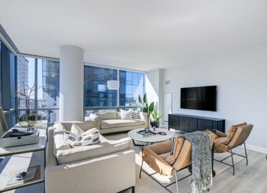 a living room with a large window and a couch and a tv