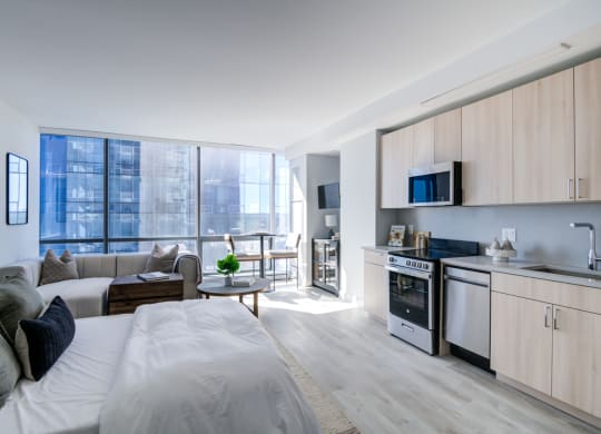 a living room with a couch and a kitchen in a apartment
