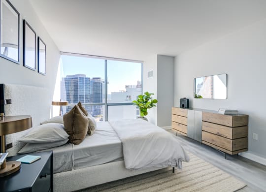 a bedroom with a bed and a large window