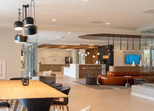 A modern lobby with a wooden table and chairs.