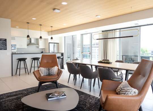 A modern living room with a brown leather chair and a grey coffee table.