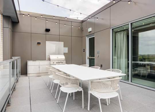 A white table and chairs are set up on a patio.