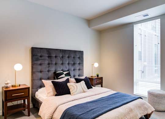 A bedroom with a large bed and a blue headboard.