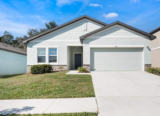 A house with a garage door that says 310 on it.