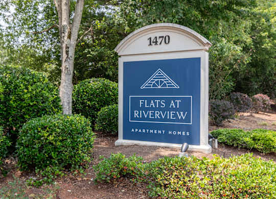 Community entrance sign at Flats at River View apartments in Duluth, GA, near Lawrenceville.