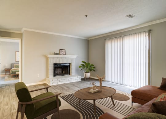 a living room with a fireplace and a couch and a table