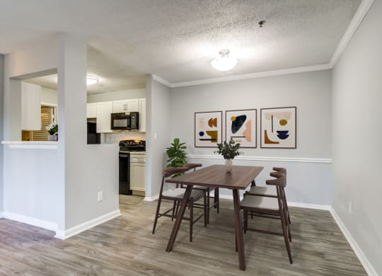a dining room with a table and chairs and a kitchen