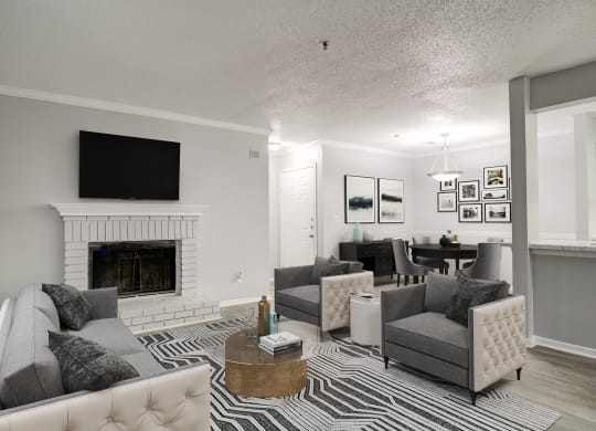 Forest Glen apartments in Austell, GA photo of a living room with a fireplace and a tv above it
