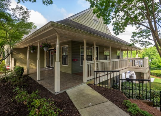 the front porch of a house with a porch swing