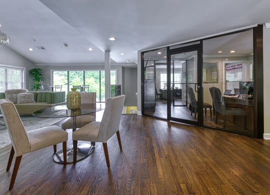 a dining room and living room with a glass table and chairs