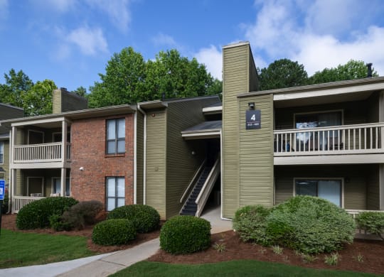 an apartment building with balconies and a sidewalk