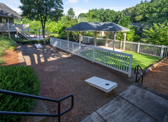 a gazebo in a park next to a house