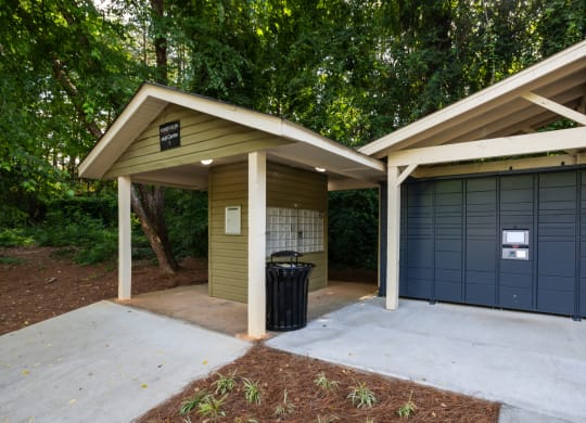 the garage has a concrete driveway and a garage door with a trash can