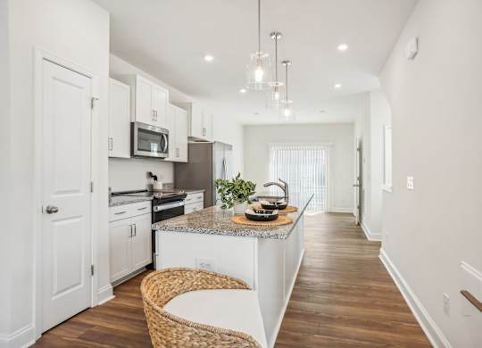 a kitchen with white cabinets and a counter top