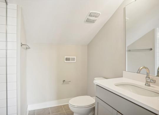 a bathroom with a toilet and a sink and a shower