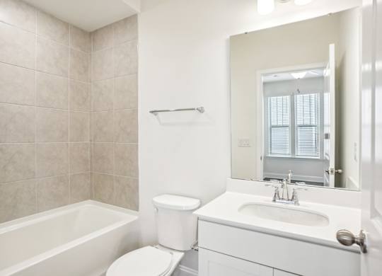 a bathroom with a sink toilet and a mirror