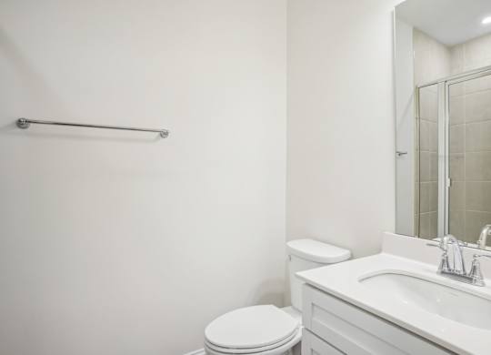 a bathroom with a sink toilet and a mirror