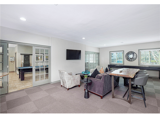 Resident clubroom with ample seating and natural light at Springdale Glen, a pet-friendly community in Clarkston, GA, near Decatur.
