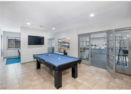Resident clubhouse with a pool table at Springdale Glen, a pet-friendly community in Clarkston, GA, near Decatur, providing a welcoming space for relaxation and socializing.