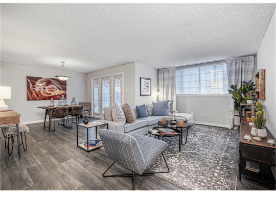 Spacious living and dining room with large windows at Springdale Glen, a pet-friendly community in Clarkston, GA, near Decatur.
