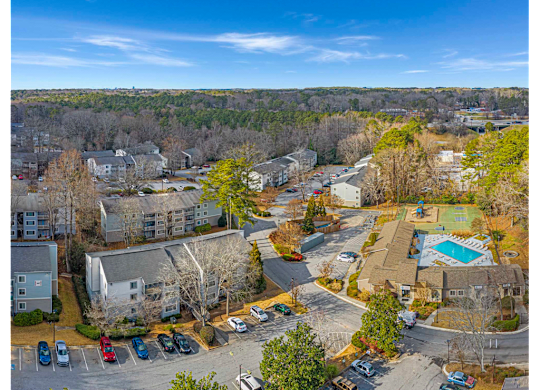 Bird’s-eye view of Springdale Glen in Clarkston, GA, near Decatur, highlighting the community’s residential buildings, pool, and landscaped grounds.