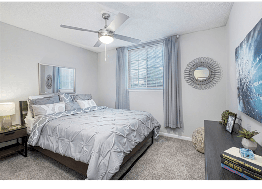 Bedroom with large windows at Springdale Glen, a pet-friendly community in Clarkston, GA, near Decatur.