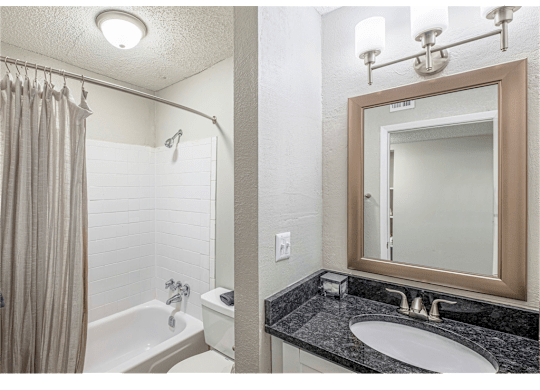 Bathroom with shower and tub at Springdale Glen, a pet-friendly community in Clarkston, GA, near Decatur.