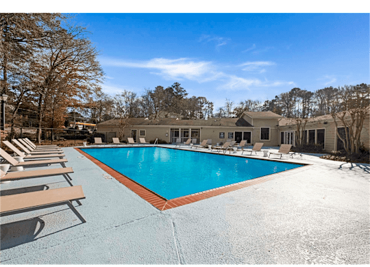 Resort-inspired pool with lounge chairs at Springdale Glen, a pet-friendly community in Clarkston, GA, near Decatur.