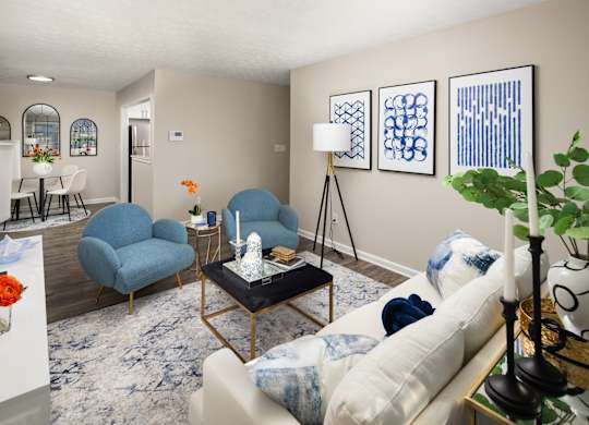 A living room with a blue chair and a white couch.