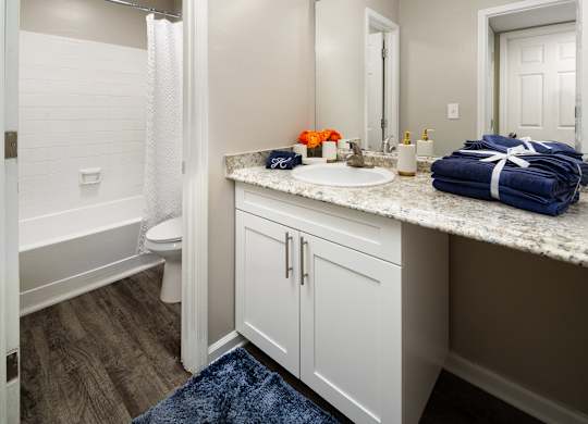 A bathroom with a white toilet, a white sink, and a white bathtub.