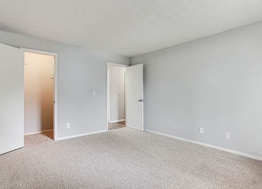 A room with carpeted floor and white walls.