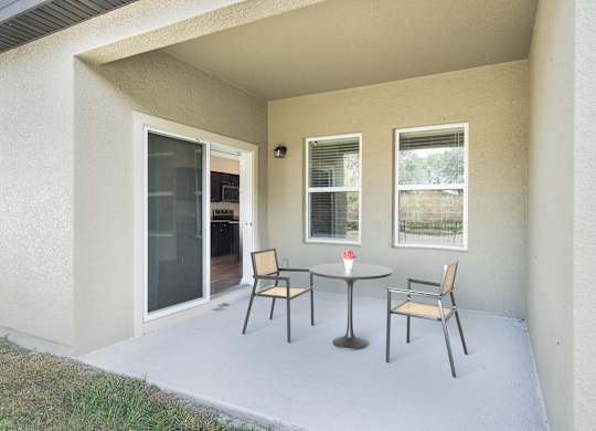 A patio with a table and chairs is shown.