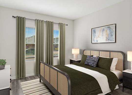 A bedroom with a large bed and a window with curtains.