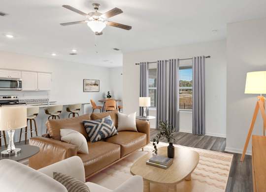 A living room with a brown leather couch and a wooden coffee table.