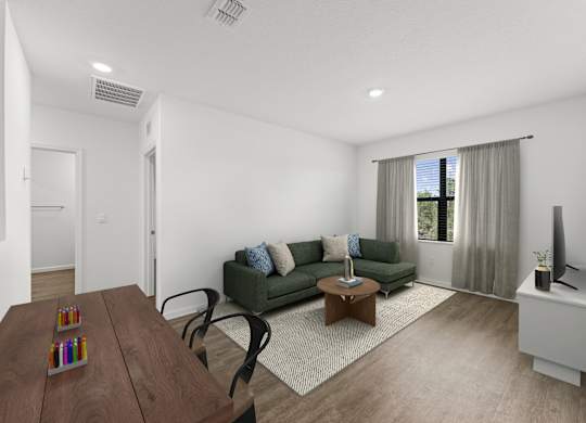 A living room with a green couch and a wooden coffee table.