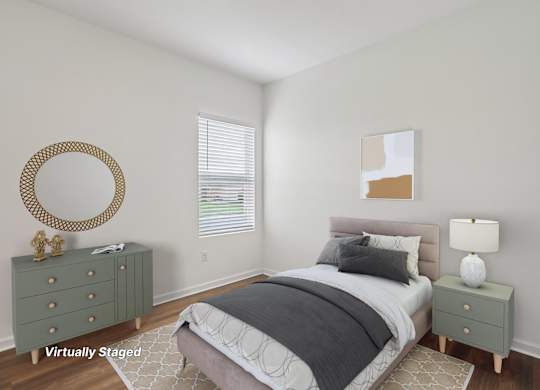 A bedroom with a bed, nightstand, and a mirror on the wall.