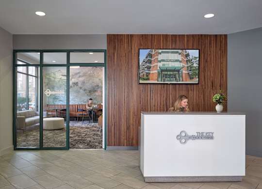 A reception area with a woman behind the desk.