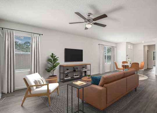 A living room with a brown couch, a television, and a ceiling fan.