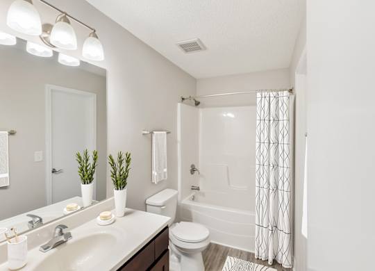 Modern bathroom with tub and shower at Hunters Pointe apartments in Charlotte, NC 28213, near UNC Charlotte.